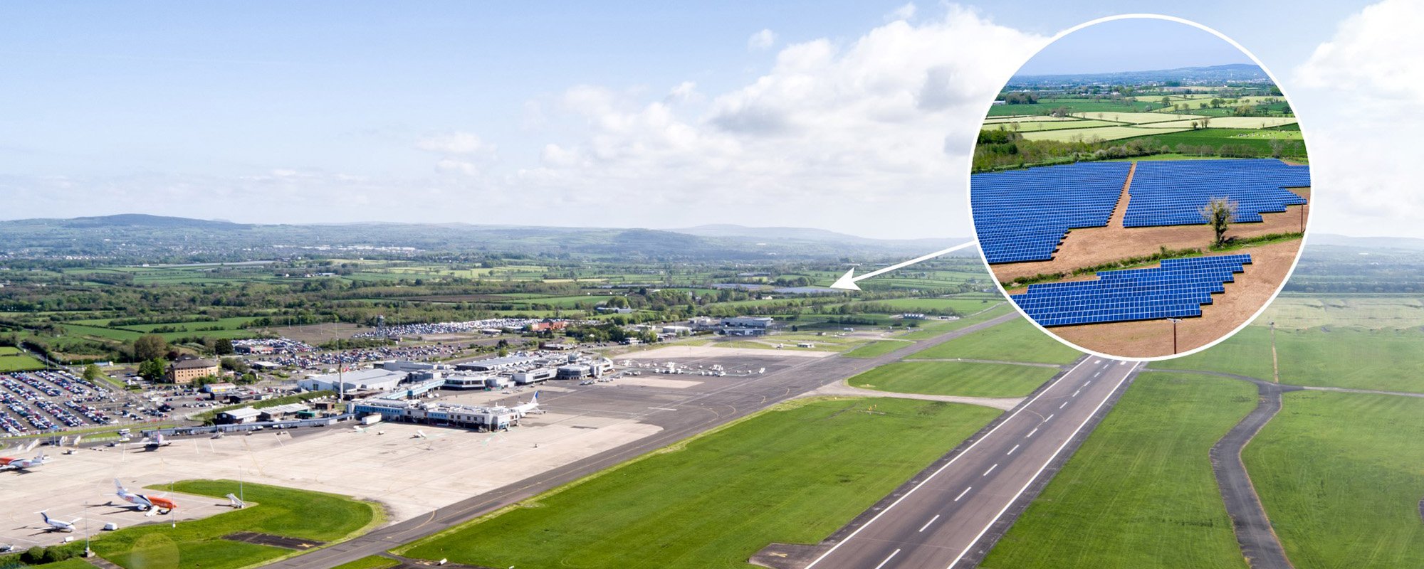 Wide aerial shot of George Best Belfast City Airport under a partly cloudy sky, with a circular inset highlighting the nearby Lightsource bp Crookedstone Road Solar Project. As a UK Projects site, this installation demonstrates how renewable energy can be integrated into urban and transport infrastructure, delivering clean power to the region.