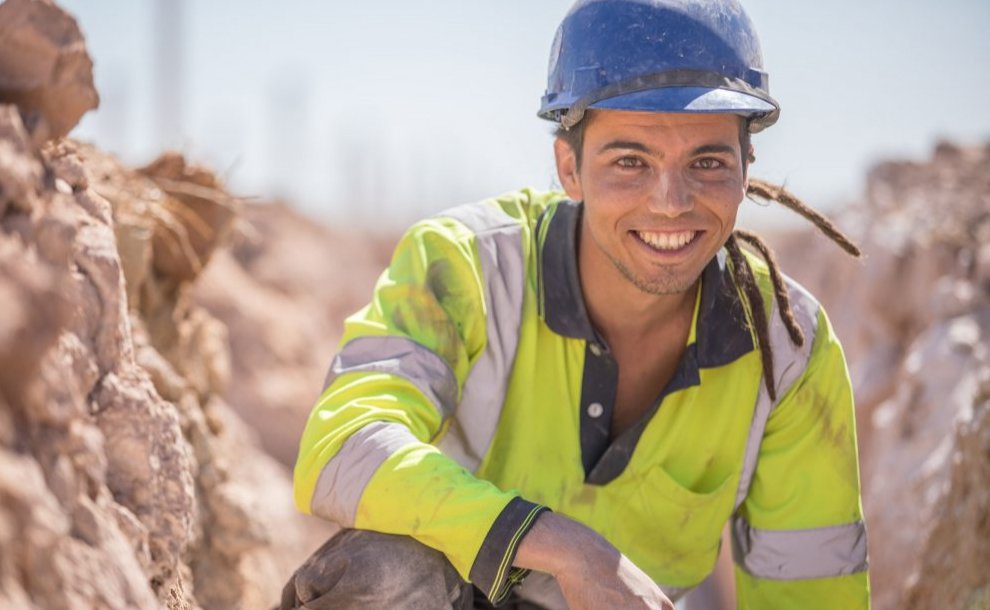 Smiling worker in a field