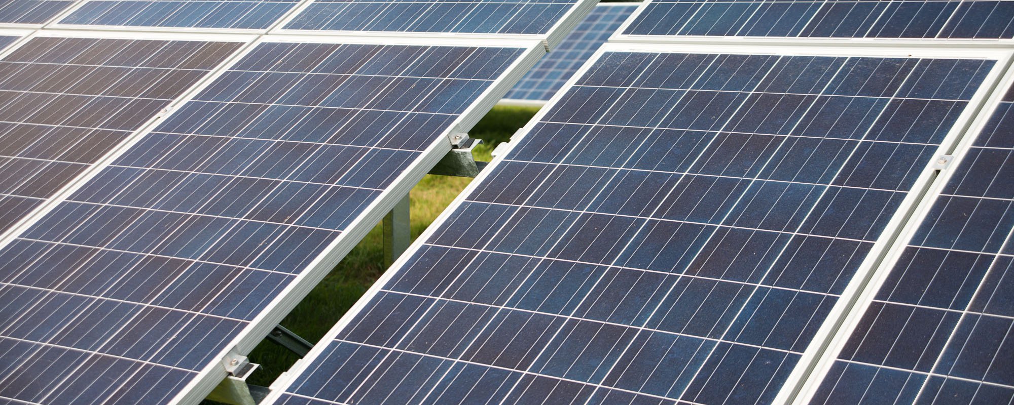 Close-up of solar panels installed on a solar farm, generating renewable energy from sunlight.