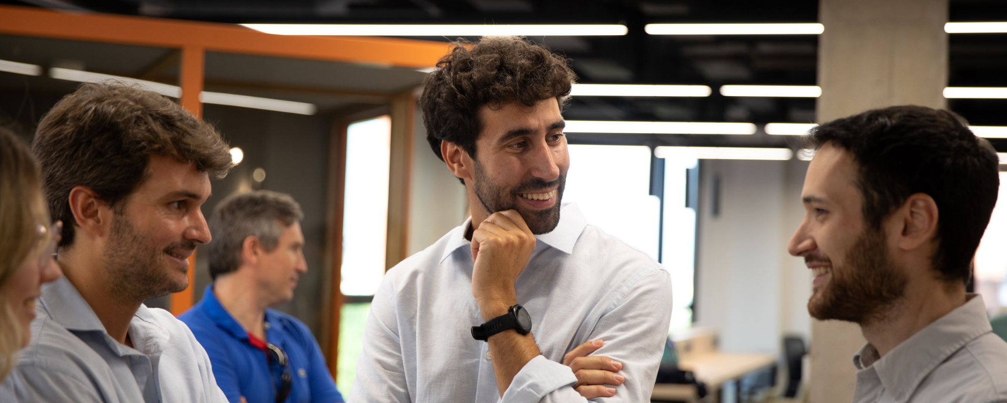 team members talking in an office