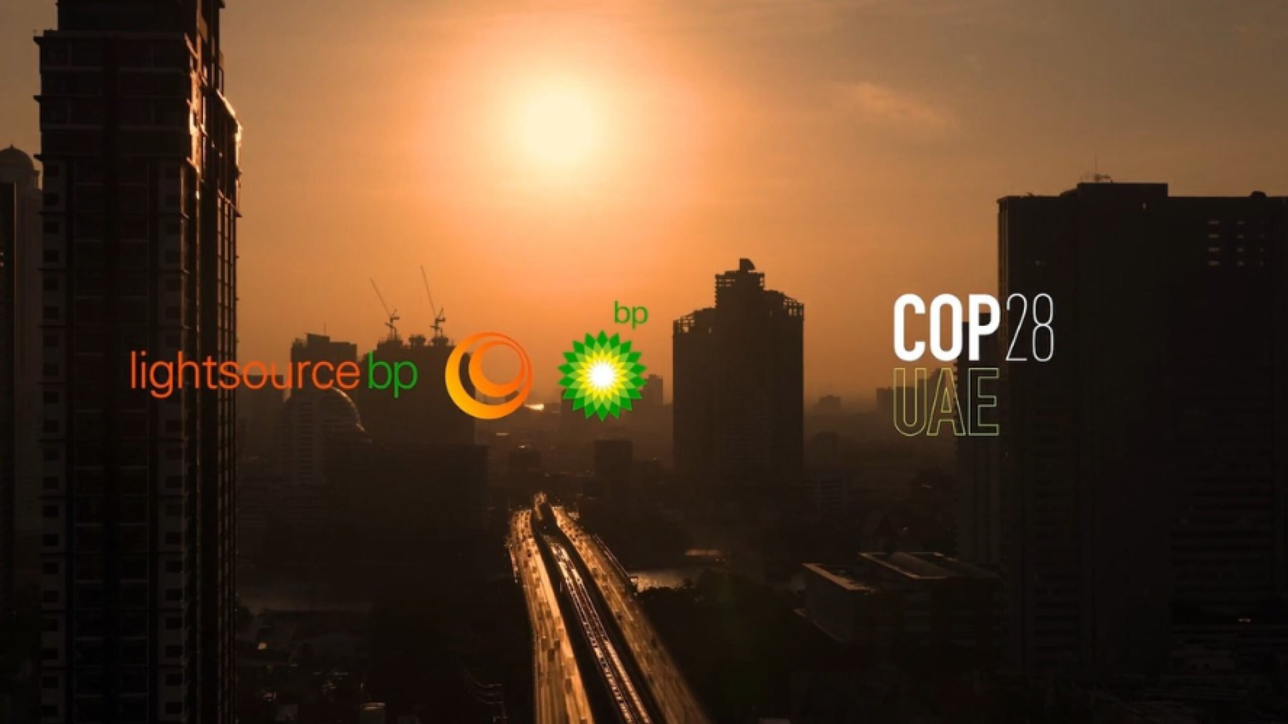 A cityscape at sunset with the Lightsource bp and bp logos, and the text 