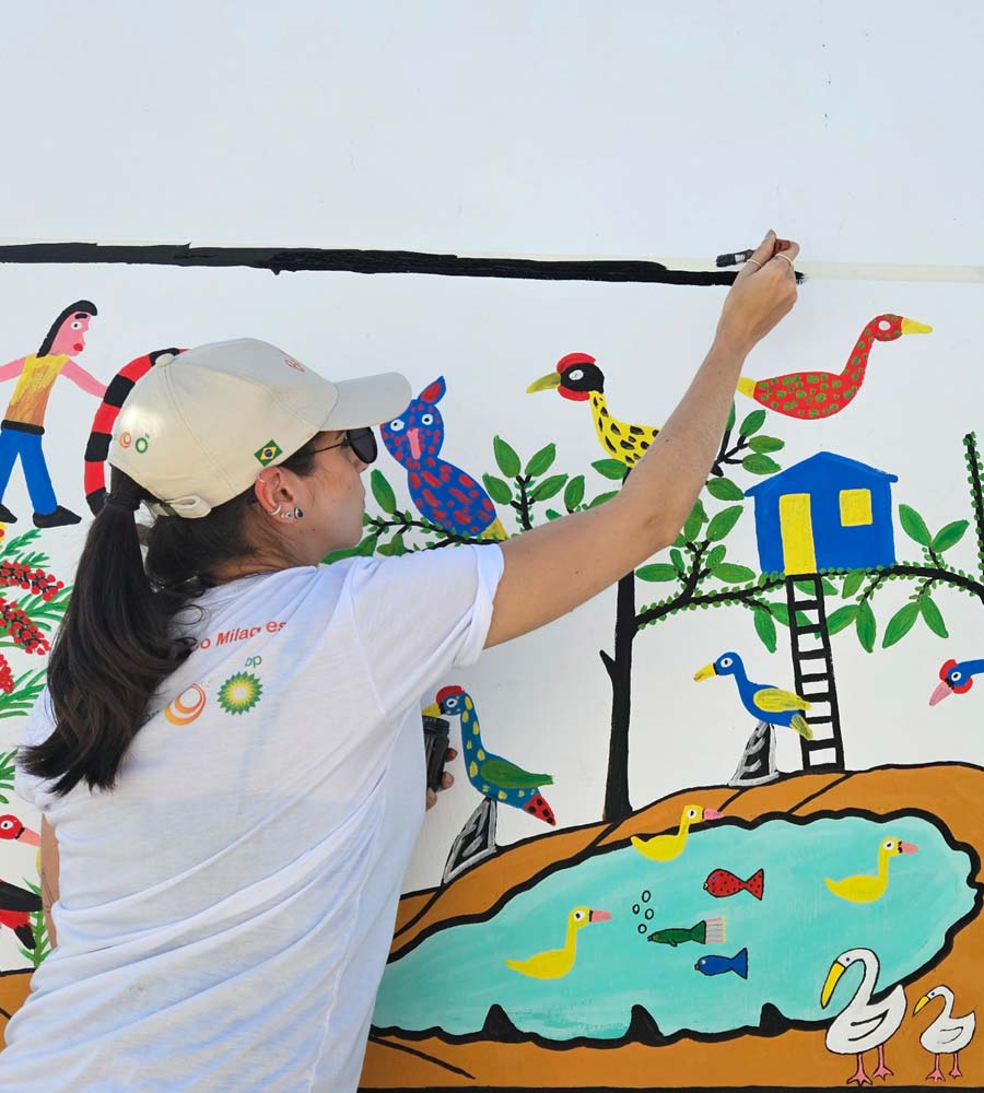 Woman painting on a mural