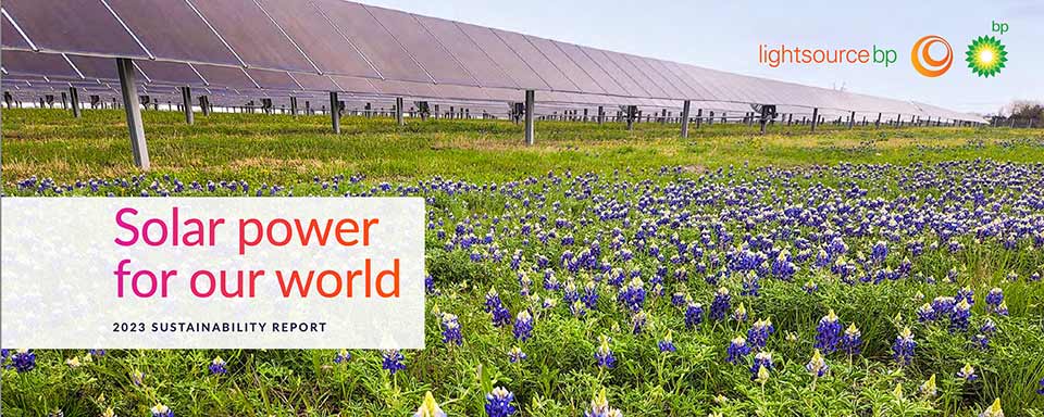 Solar power field with panels and wildflowers from Lightsource BP's 2023 sustainability report promoting renewable energy.