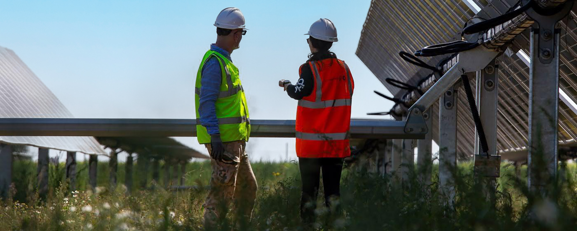 two team members in full PPE on a solar