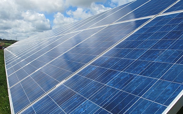 Close-up of solar panels installed on a solar farm, generating renewable energy from sunlight.
